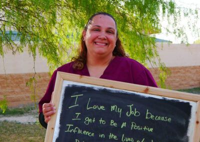 A picture of a person holding a chalk board